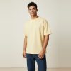 Model wearing butter yellow plain t-shirt, colour code #F6E3A1 – Bulk Cloth Store