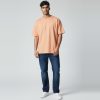 Model wearing peach plain t-shirt, colour code #F4B393 – Bulk Cloth Store